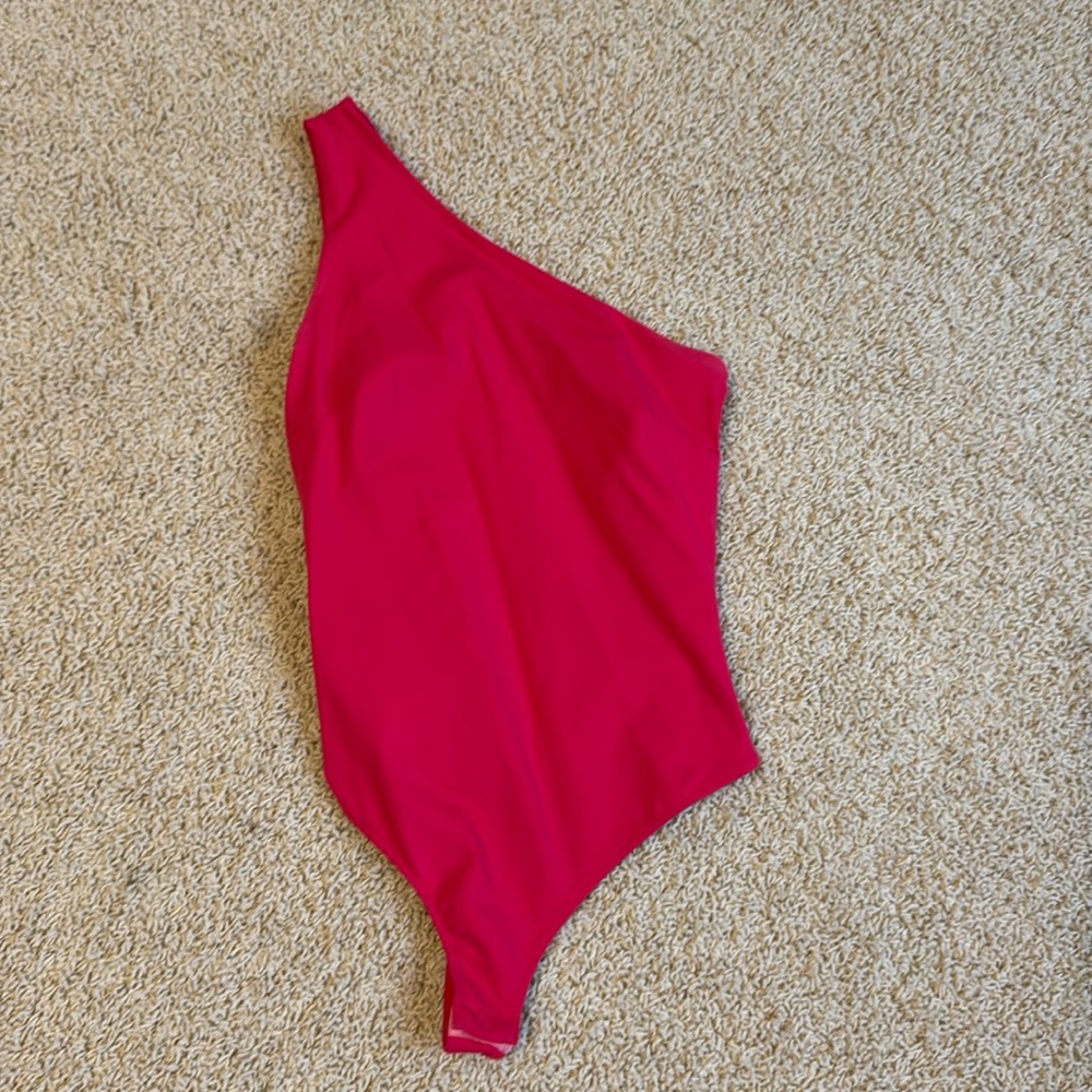 Free People one shoulder pink bodysuit. Snaps at the bottom. Size small.